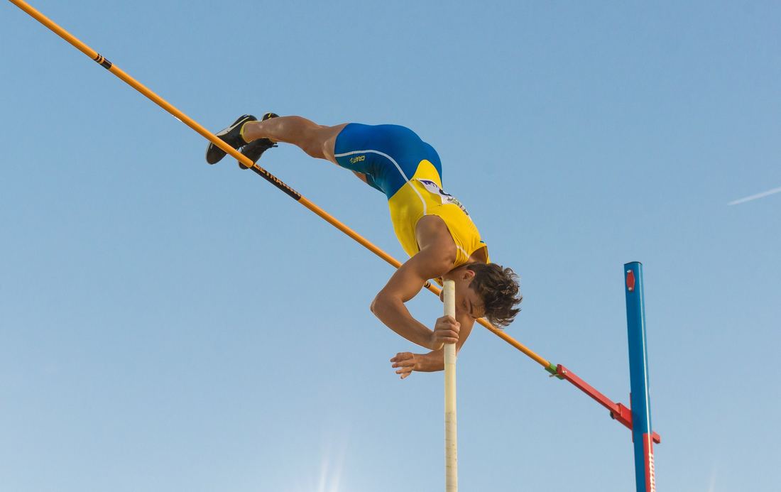 Armand Duplantis in the air clearing a bar at 6 metres